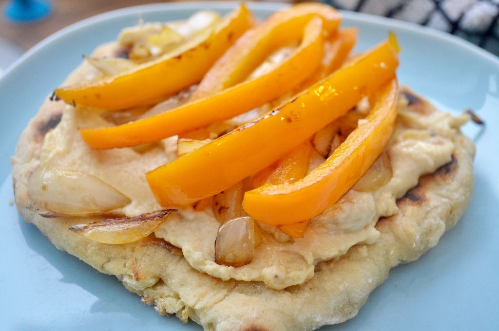 Flatbreads with houmous, peppers, and onions